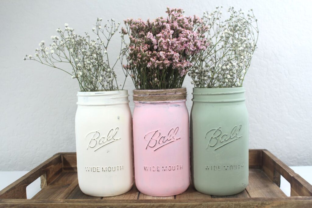 Try different colors and coordinate with holiday table decor. Here are three painted mason jars as vases for a dinner centerpiece. 